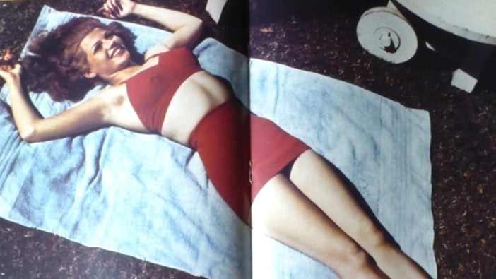 Rita Hayworth in swimming suit centerfold still in magazine.