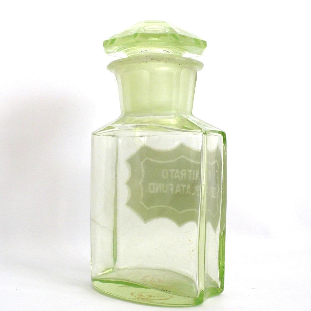 Uranium glass apothecary bottle under regular light.